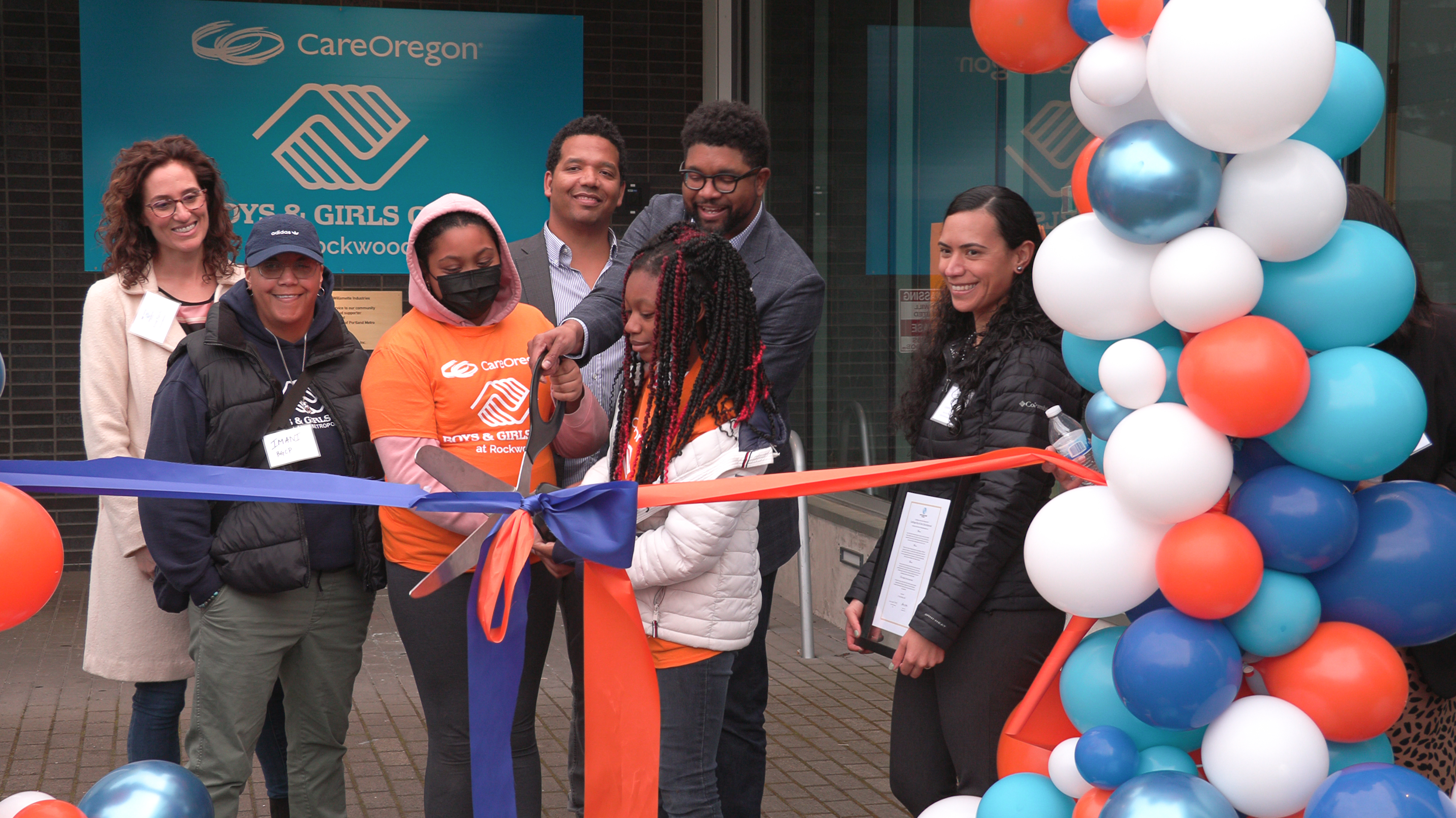 A group of people cut a ribbon at the CareOregon Boys & Girls Club at Rockwood ceremony