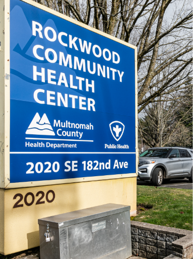 An outdoor sign for the Rockwood Community Health Center located at 2020 SE 182nd Ave, Portland, OR