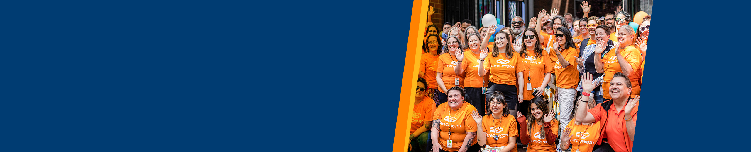 Two people standing side by side with their arms crossed in black and white against a textured orange background.